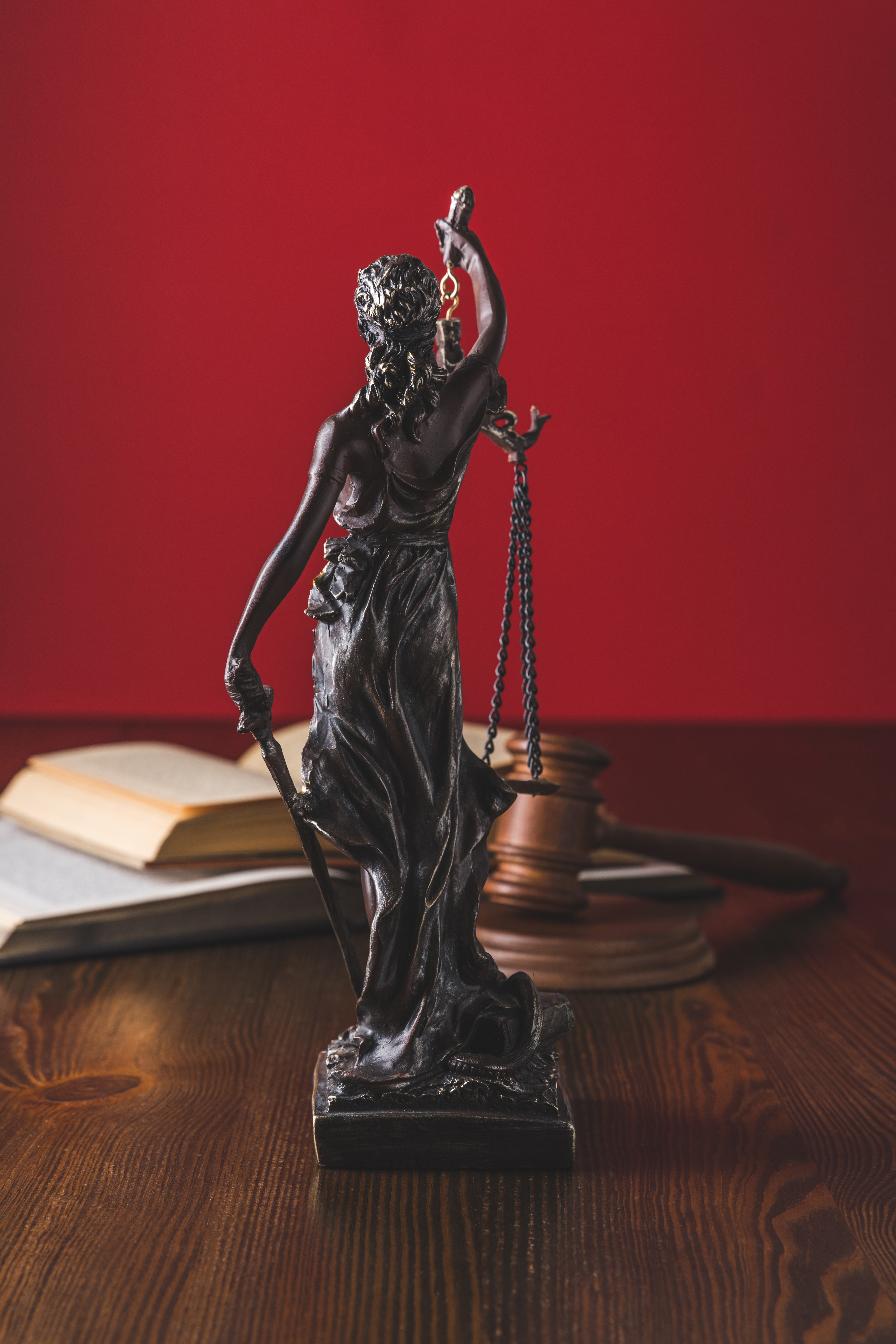 Law books and justice statue in legal office